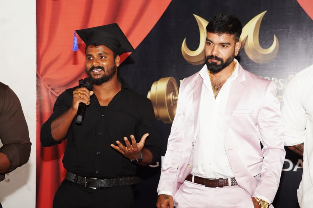 Manikandan on stage with graduate at physical culture ceremony